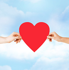 Image showing couple hands holding red heart