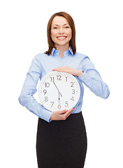 Image showing attractive businesswoman with wall clock