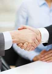 Image showing two businessmen shaking hands in office