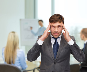 Image showing stressed buisnessman or teacher having headache