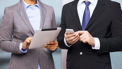 Image showing two businesspeople with smartphone and tablet pc