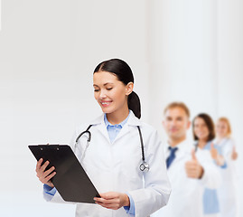 Image showing smiling female doctor with clipboard