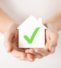 Image showing hands holding house with check mark