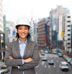 Image showing businesswoman in white helmet with crossed arms