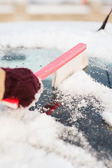 Image showing woman cleaning snow from car back window