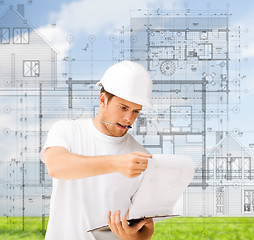 Image showing male architect looking at blueprint