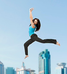 Image showing sporty woman jumping in sportswear