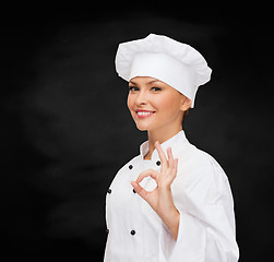 Image showing smiling female chef showing ok hand sign