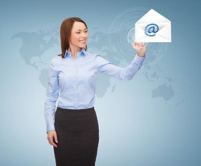 Image showing smiling businesswoman working with virtual screen