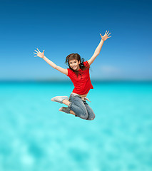 Image showing smiling girl jumping