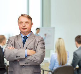 Image showing serious businessman or teacher in suit at office
