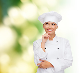 Image showing smiling female chef dreaming