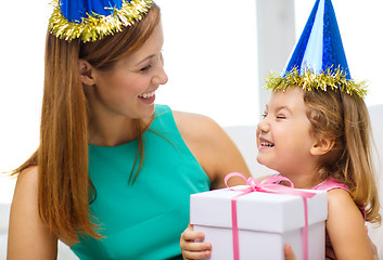 Image showing mother and daughter in blue hats with favor horns