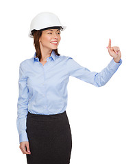 Image showing young smiling businesswoman in white helmet