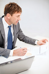 Image showing businessman with laptop computer and documents