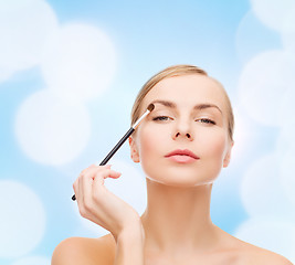 Image showing beautiful woman with makeup brush