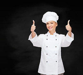 Image showing smiling female chef showing thumbs up