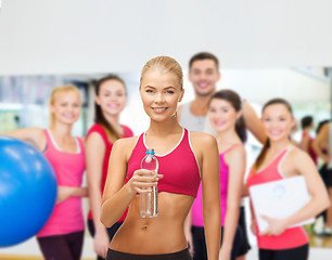 Image showing smiling woman with bottle of water