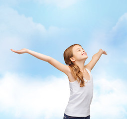 Image showing smiling teenage girl with raised hands