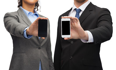 Image showing businessman and businesswoman with smartphones