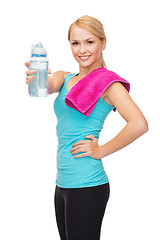 Image showing sporty woman with towel and watel bottle