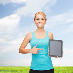 Image showing sporty woman with tablet pc blank screen