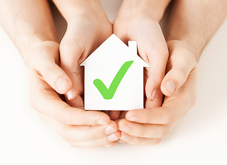Image showing hands holding house with check mark