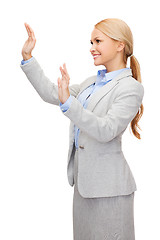 Image showing smiling businesswoman pointing to something