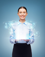 Image showing businesswoman with tablet pc and world hologram