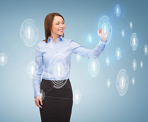 Image showing smiling businesswoman working with virtual screen