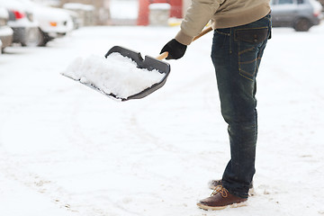 Image showing closeup of man shoveling snow from driveway