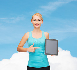 Image showing sporty woman with tablet pc blank screen