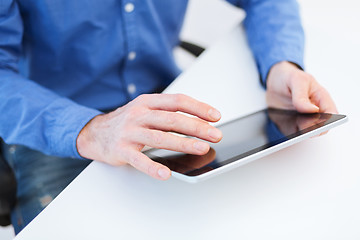 Image showing close up of male hands working with tablet pc