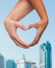 Image showing woman and man hands showing heart shape