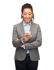 Image showing smiling woman looking at smartphone