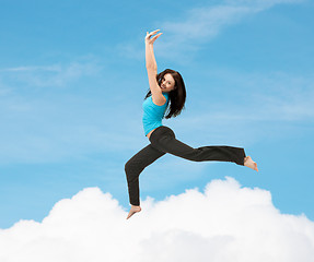 Image showing sporty woman jumping in sportswear