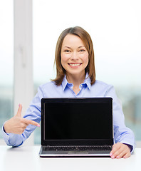 Image showing businesswoman with blank black laptop screen