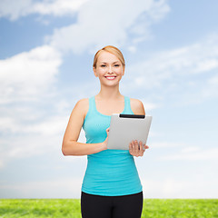 Image showing sporty woman with tablet pc