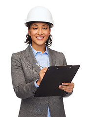 Image showing businesswoman in white helmet with clipboard