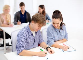 Image showing smiling students with notebooks at school