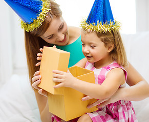 Image showing mother and daughter in blue hats with favor horns