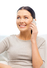 Image showing smiling woman with smartphone at home