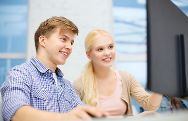 Image showing smiling teenage boy and girl in computer class