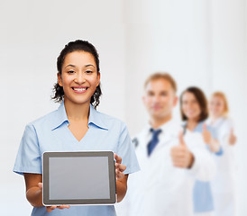 Image showing smiling female doctor or nurse with tablet pc