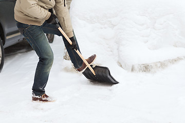 Image showing closeup of man shoveling snow from driveway