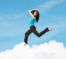 Image showing sporty woman jumping in sportswear
