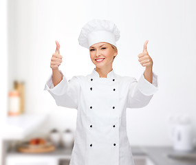 Image showing smiling female chef showing thumbs up