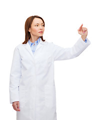 Image showing doctor pointing to something or pressing button