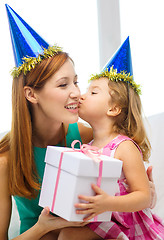 Image showing mother and daughter in blue hats with favor horns