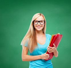 Image showing smiling student with folders